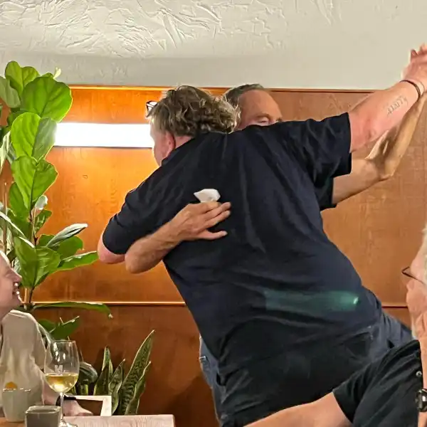Two of the men crew members dancing in the restaurant, celebrating their safe return to port after a stormy sea crossing.